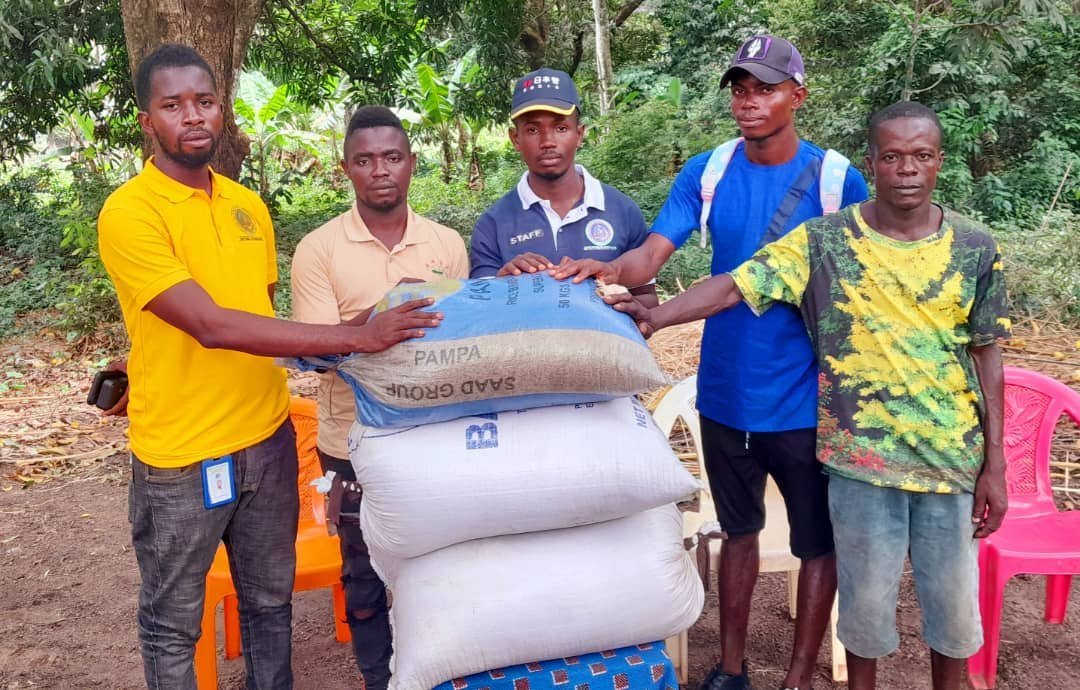 Project representatives and community members with seedling bags
