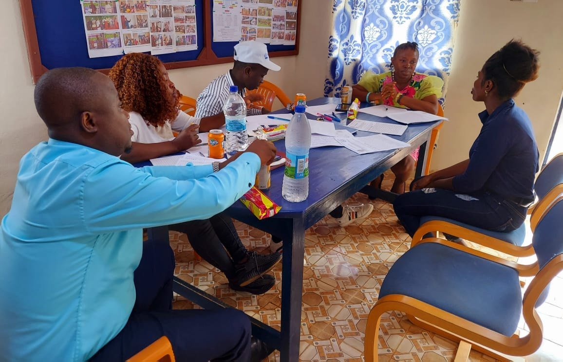 Students and facilitators meeting around a table